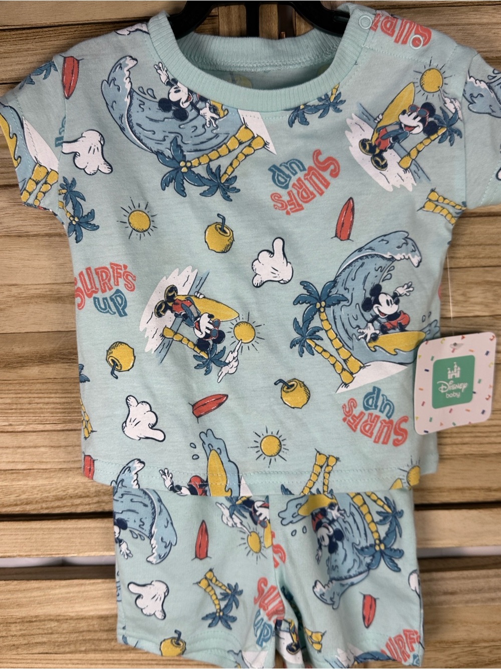 Disney two -piece with Mickey Mouse surfing and beach graphics. 0-3 nwt